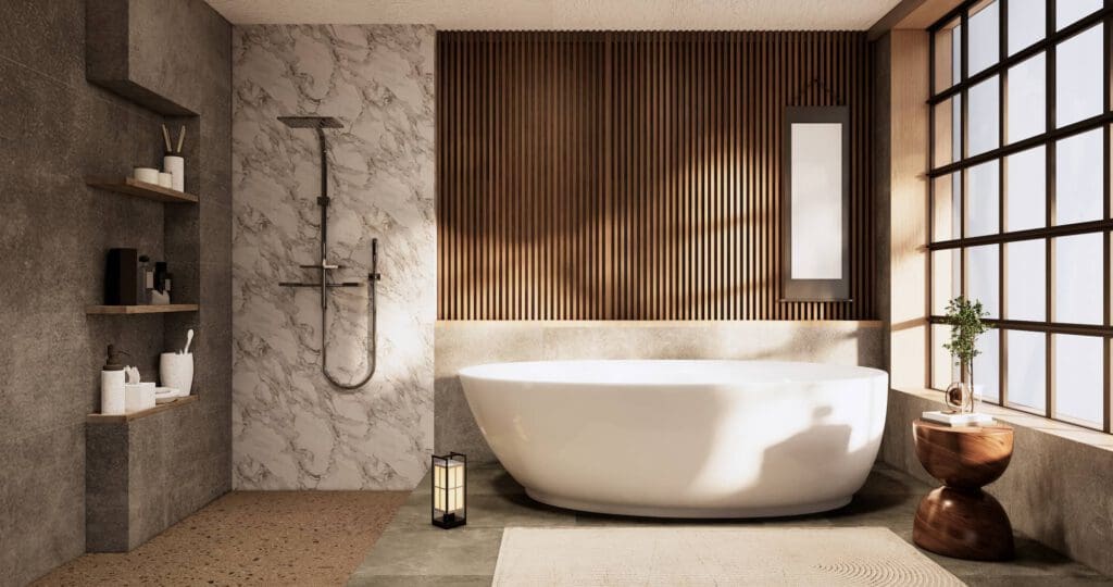 Modern bathroom with a freestanding white bathtub, wall-mounted shower, wooden accent wall, shelves with toiletries, a large window with natural light, a small table with a plant, and a lantern on the floor.